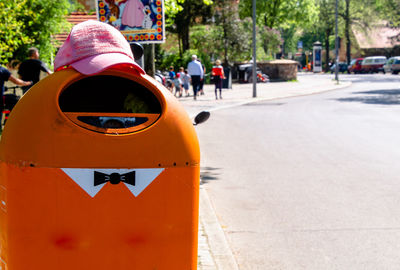 Rear view of garbage can on city street