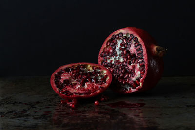 Close-up of fruits on table against black background