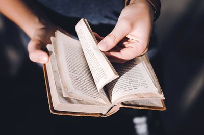 Close-up of hands holding book