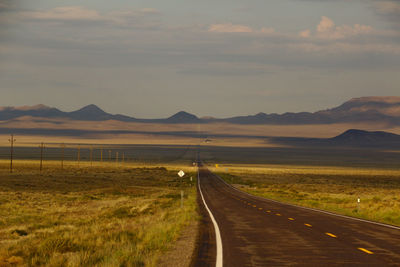 Road amidst landscape against sky during sunset