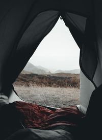 Scenic view of mountains against sky seen through tent