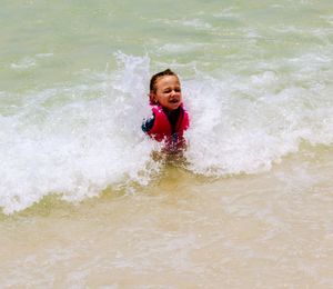 Full length of happy boy in sea