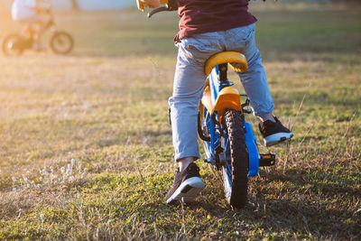 Low section of boy riding bicycle at park