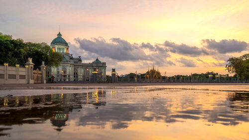 Reflection of buildings in water at sunset