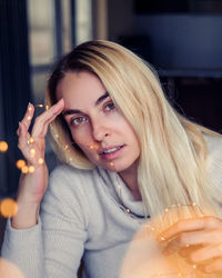 Portrait of young woman drinking glass