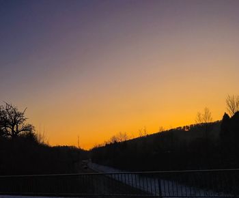 Silhouette trees against sky during sunset