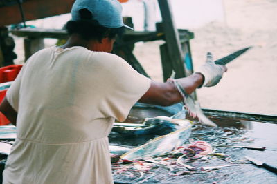 Rear view of woman selling fish