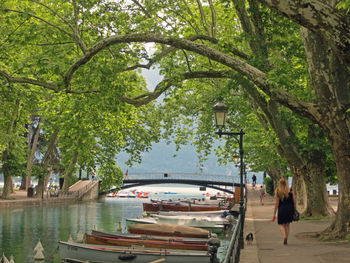 Rear view of people walking on canal