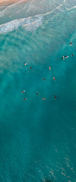 High angle view of people swimming in sea