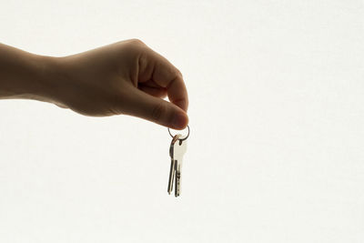 Close-up of woman hand against white background