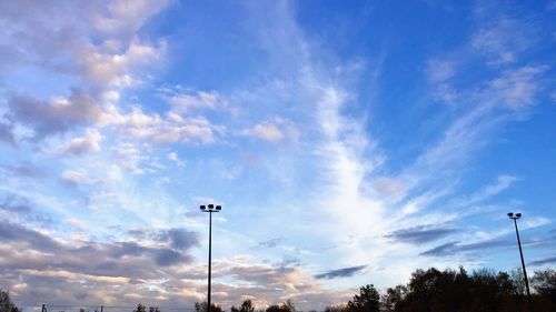 Low angle view of street light against cloudy sky