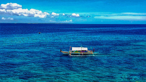 Scenic view of sea against blue sky