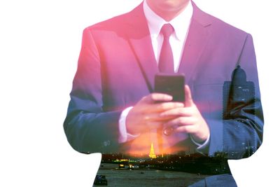 Double exposure image of businessman using phone against white background