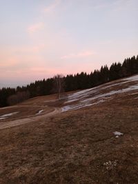 Scenic view of land against sky during sunset