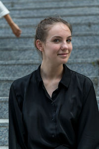 Portrait of smiling woman sitting on steps