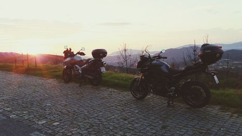 Bicycles parked against clear sky during sunset