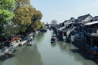 Boats in canal along buildings