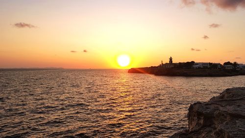 Scenic view of sea against orange sky