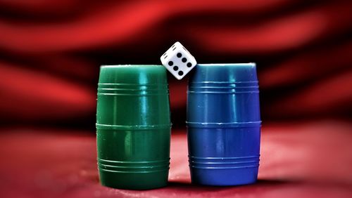 Close-up of dice on tokens against red fabric