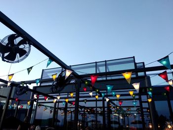 Low angle view of illuminated lights against clear sky