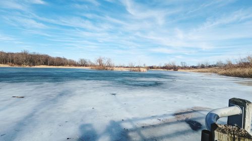 Scenic view of snow covered field against sky