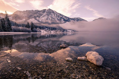 Scenic view of lake and snowcapped mountains against sky