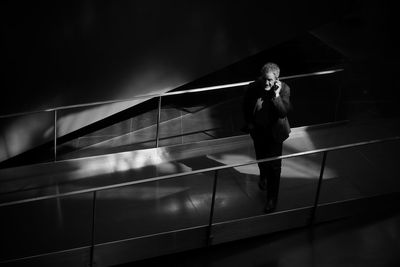 Full length of woman standing on railing