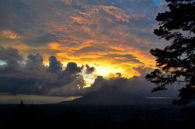 Silhouette of landscape against cloudy sky