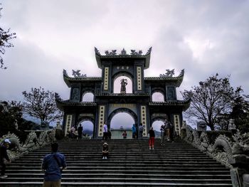 Low angle view of historical building against cloudy sky