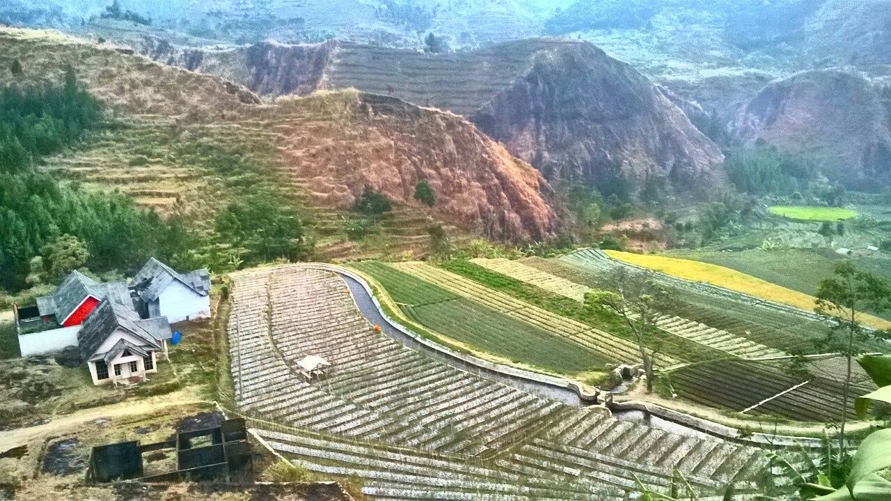 landscape, mountain, high angle view, tranquility, scenics, tranquil scene, nature, beauty in nature, rock formation, non-urban scene, travel destinations, physical geography, mountain range, day, travel, remote, built structure, village, idyllic, rural scene