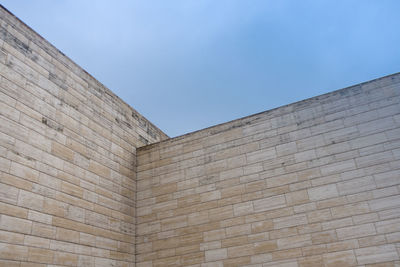 Low angle view of building detail against blue sky