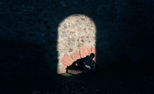 High angle view of woman sitting on floor against wall