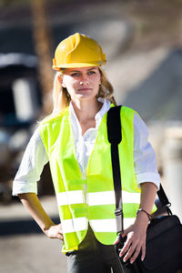 Architect wearing reflective clothing standing outdoors