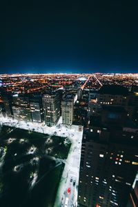 High angle view of city lit up at night