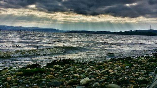 Scenic view of sea against cloudy sky