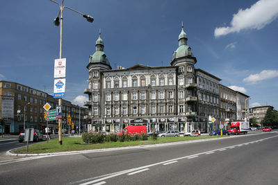 Road by street against sky in city