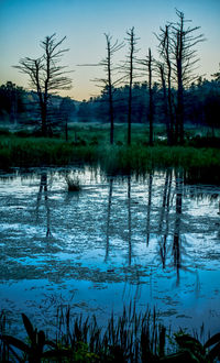 Scenic view of lake against sky at sunset