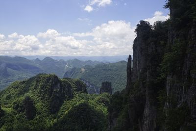 Panoramic view of trees and mountains against sky