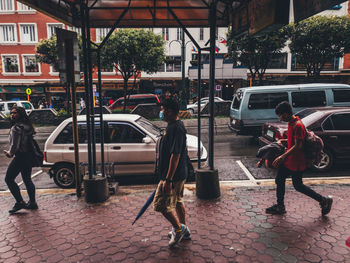 People waiting on street in city