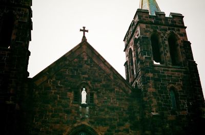 Low angle view of bell tower against sky