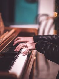 Midsection of person playing piano