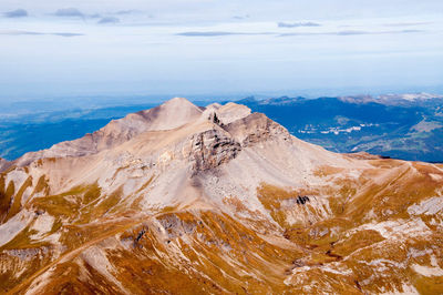 Scenic view of sea and mountains against sky