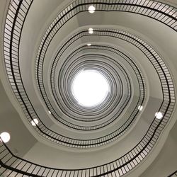 Directly below shot of spiral staircase against sky