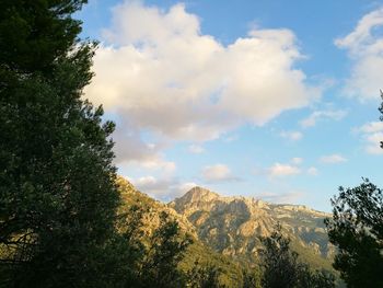 Scenic view of mountains against cloudy sky