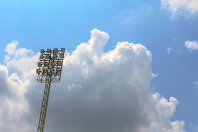 Low angle view of floodlight against cloudy sky