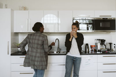 Friends standing at home