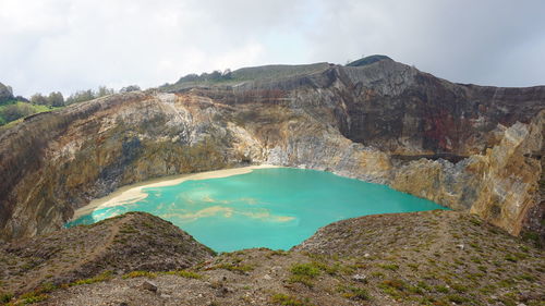 Scenic view of mountain against cloudy sky