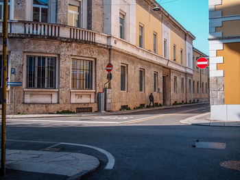 Road by buildings in city