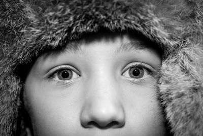 Close-up portrait of teenage boy wearing fur hat
