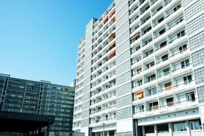 Low angle view of modern buildings against clear blue sky